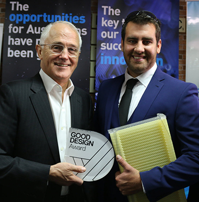 Evolve Group managing director Ty Hermans (right) is congratulated on Evolve's 2016 Good Design Award by Prime Minister Malcolm Turnbull.